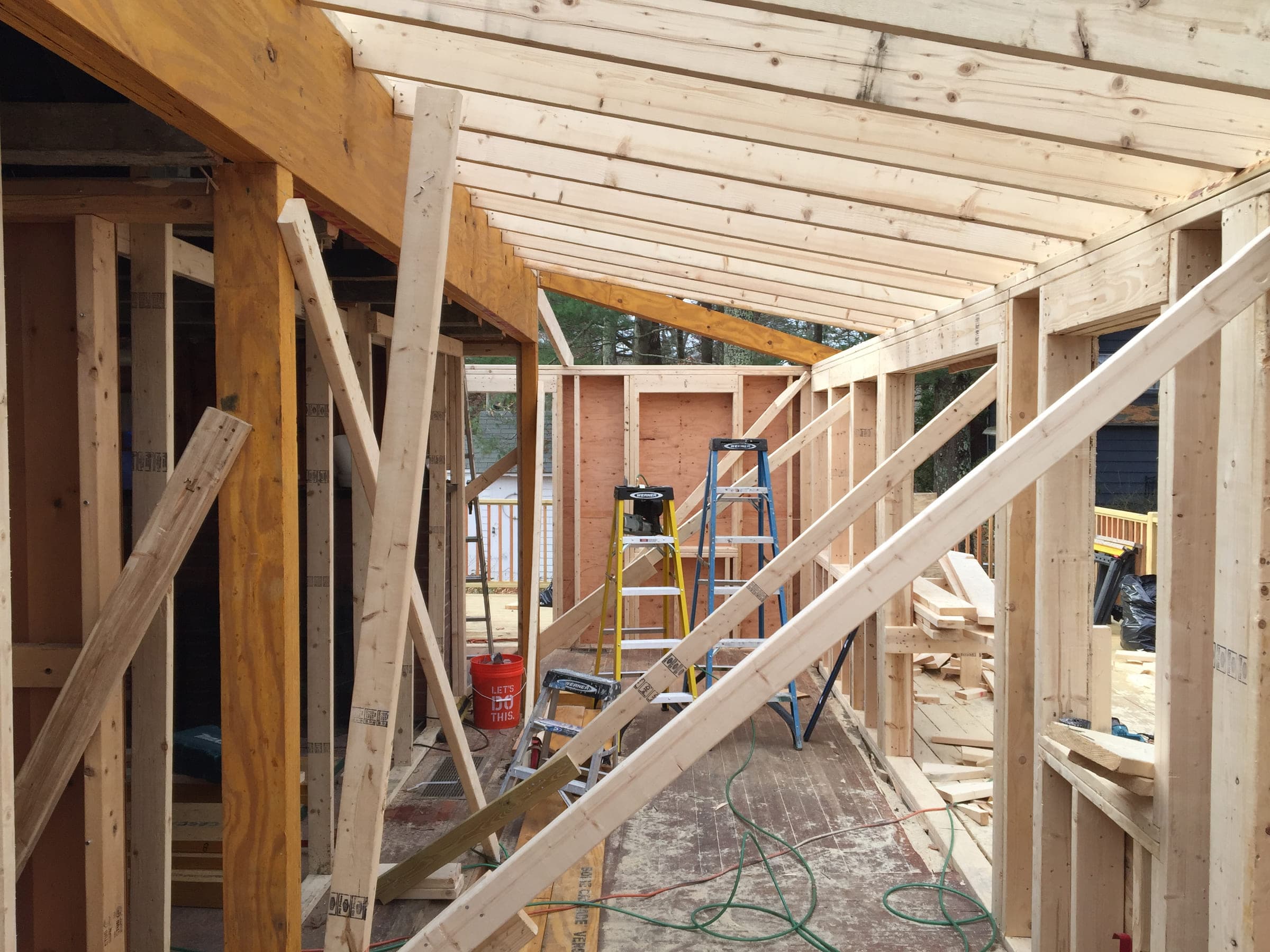 Interior of a new timber frame showing stud walls, rafters and temporary bracing