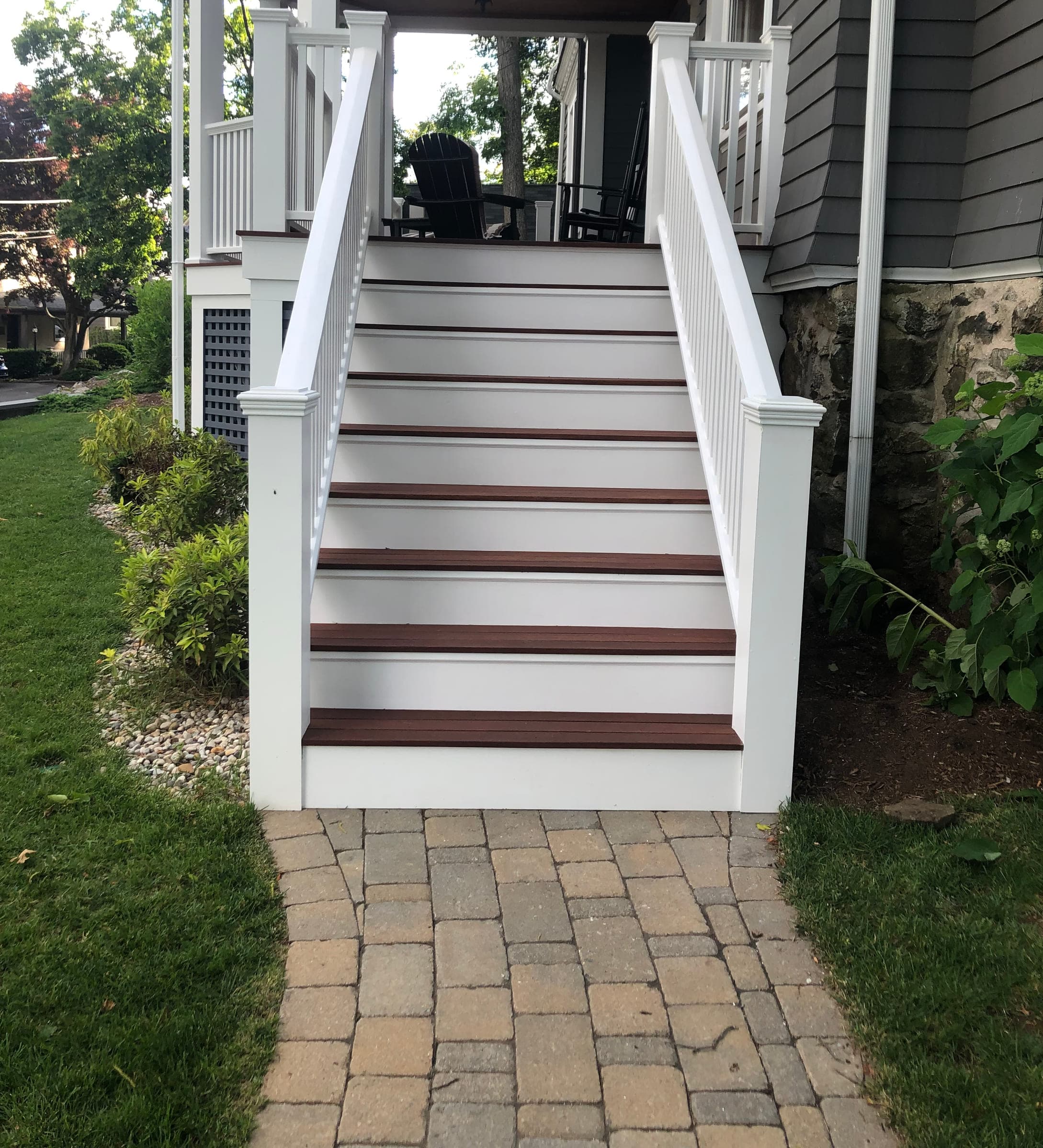 Rebuilt front porch with hardwood treads, painted risers and a white painted balustrade
